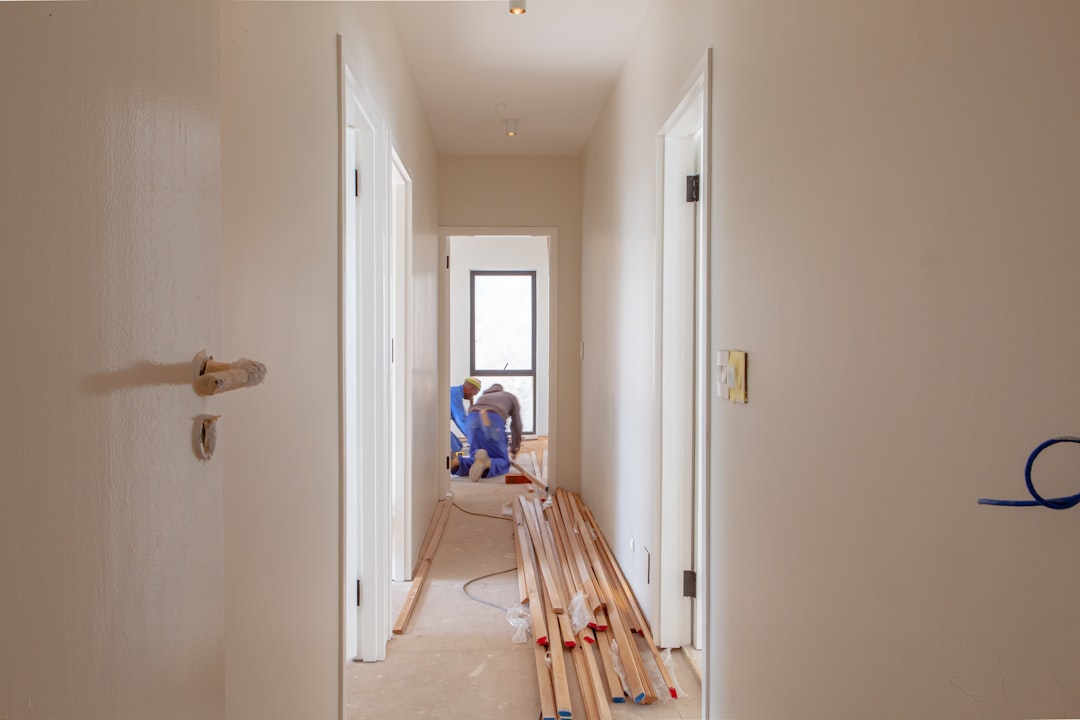 a-couple-of-men-working-on-a-house-ut6gwxh3oqq